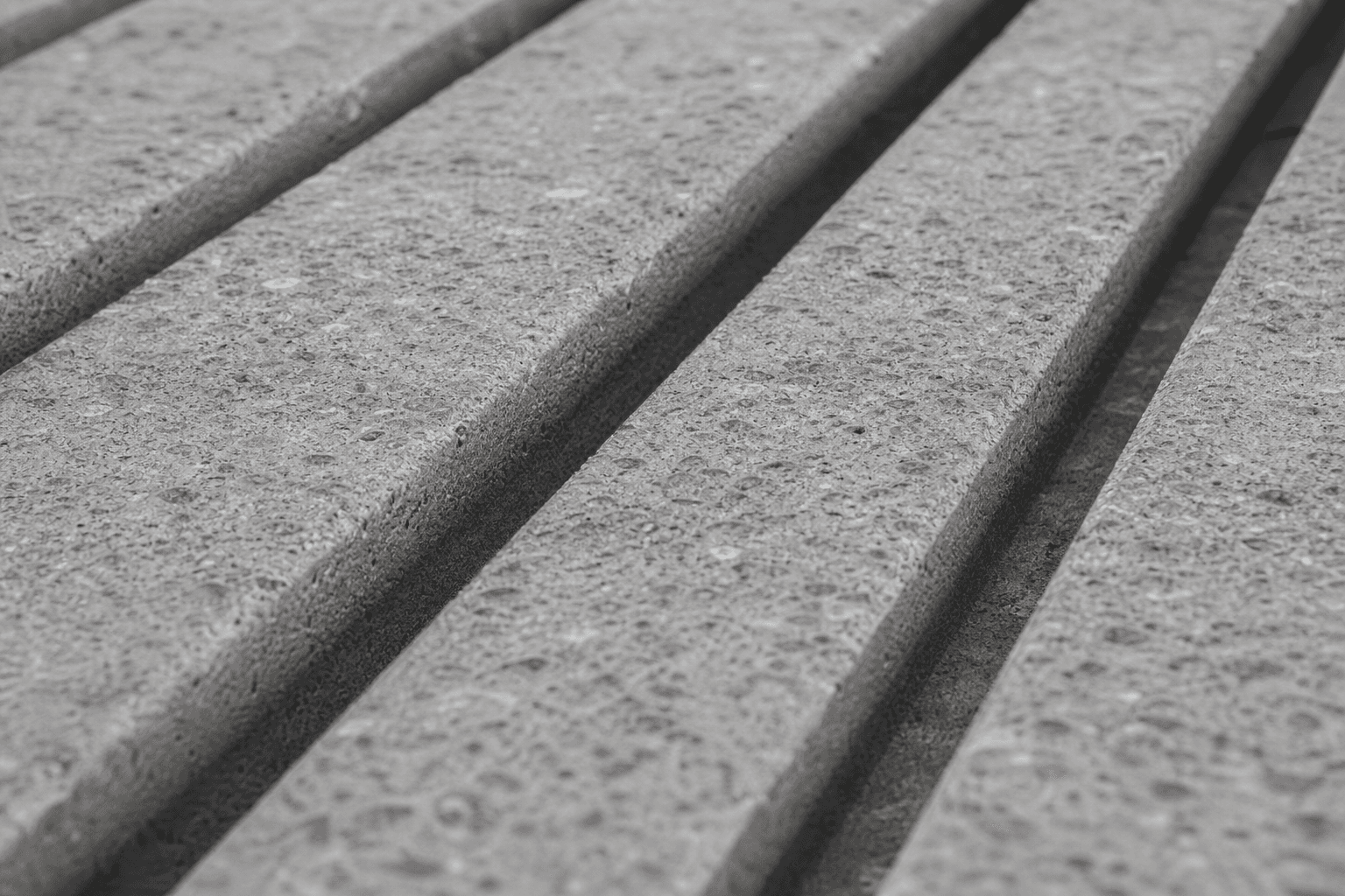 Close-up of square-edged concrete grooving cut to Dairyland Initiative spacing standard for dairy cattle traction